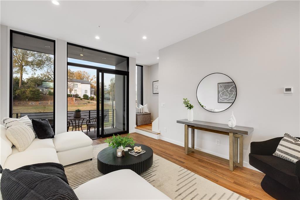 105 Georgia Avenue Southeast, Unit 1 Atlanta, GA 30312 - Photo 8 of 40 a living room with furniture a table and a large window