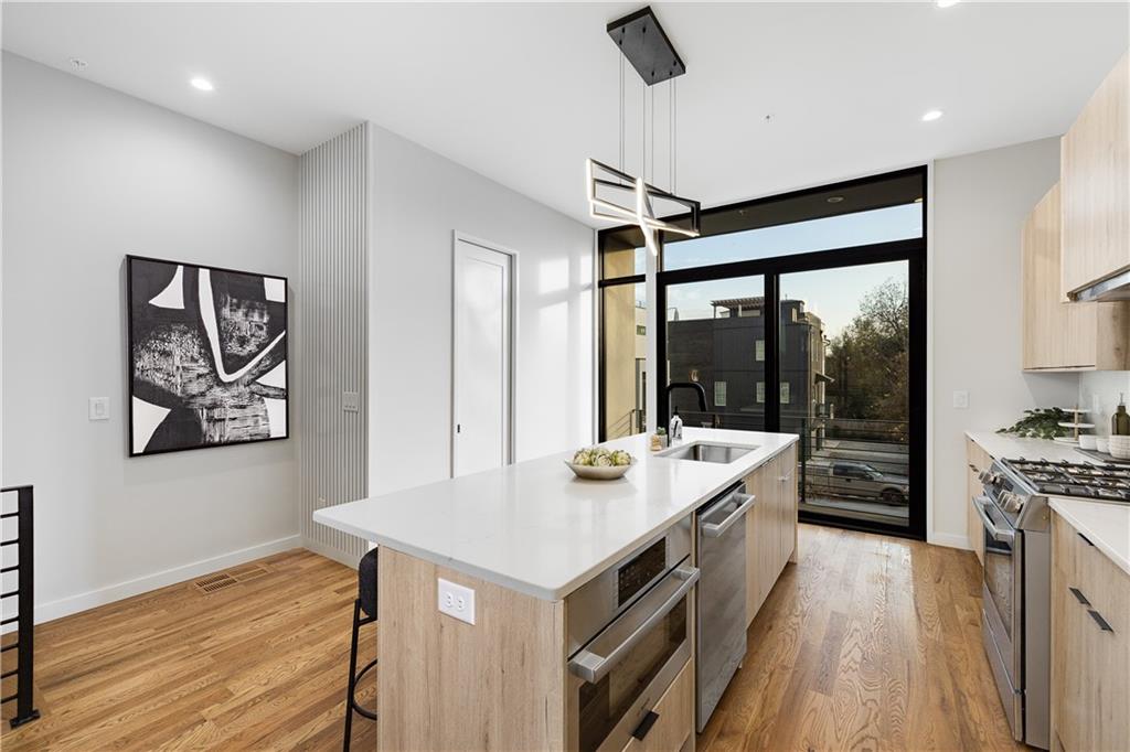 105 Georgia Avenue Southeast, Unit 1 Atlanta, GA 30312 - Photo 10 of 40 a kitchen with a stove and a refrigerator