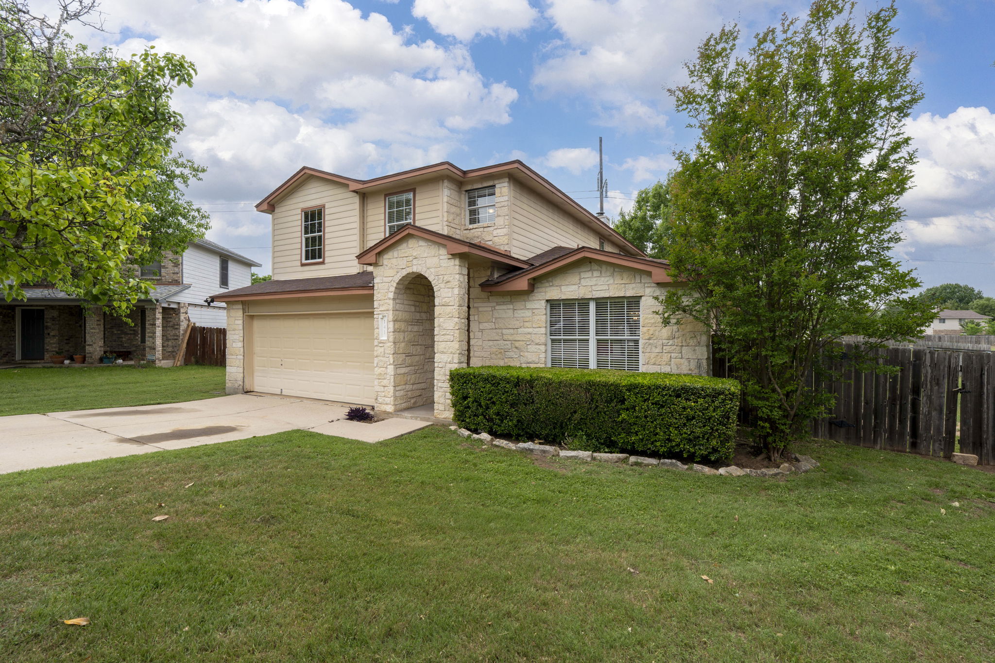 a front view of a house with a yard and garage