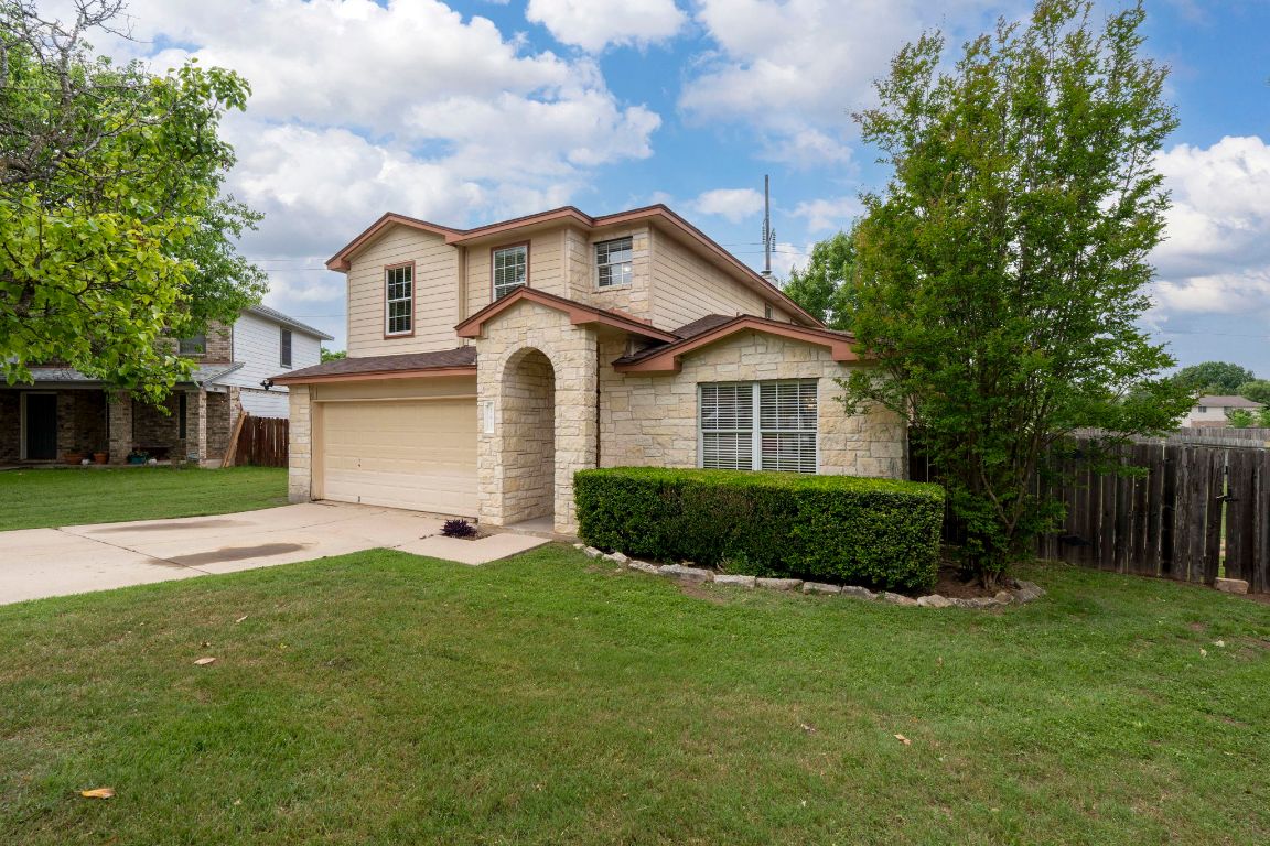 141 Sydney's Way Buda, TX 78610 - Photo 1 of 37 a front view of a house with a yard and garage