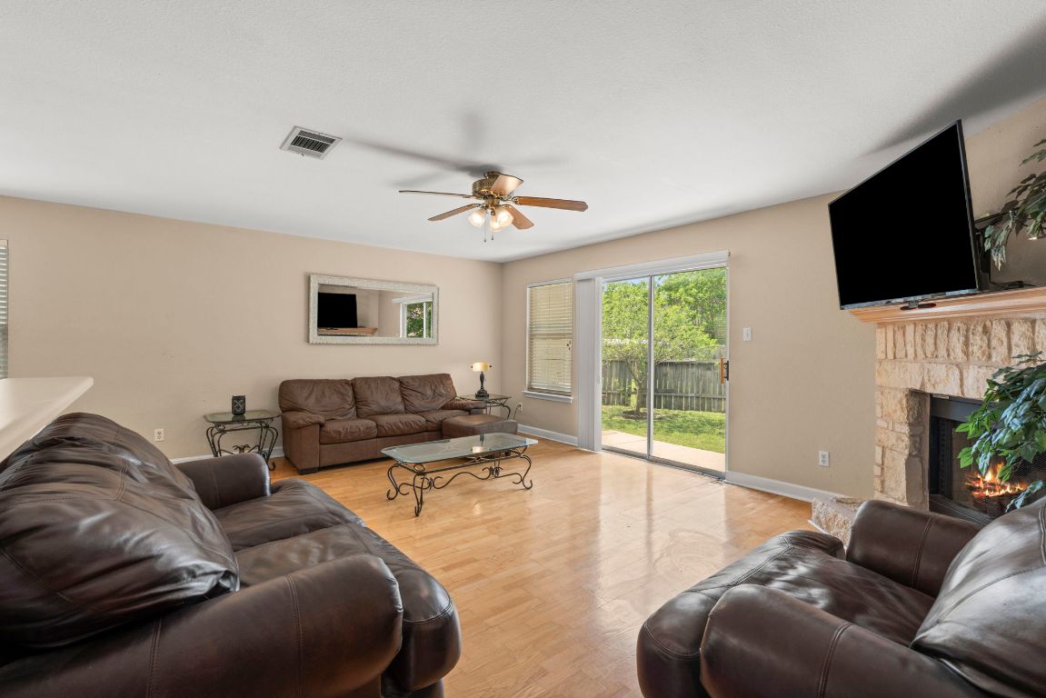 141 Sydney's Way Buda, TX 78610 - Photo 16 of 37 a living room with furniture a flat screen tv and a large window