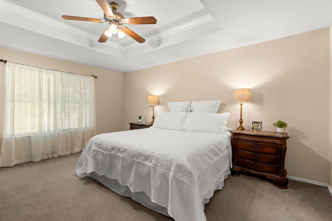 141 Sydney's Way Buda, TX 78610 - Photo 17 of 37 a bed room with a bed dresser and a window