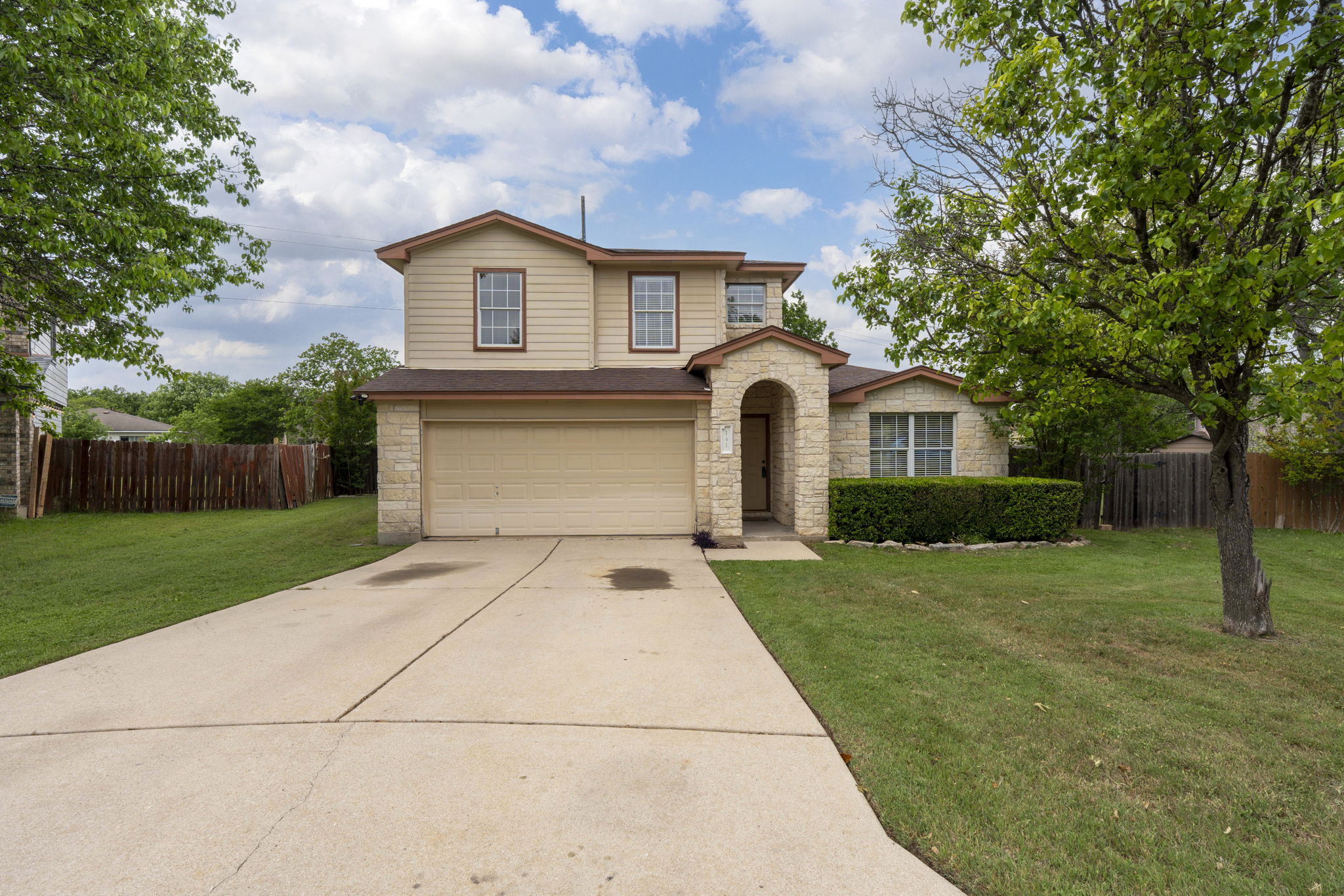 141 Sydney's Way Buda, TX 78610 - Photo 2 of 37 a front view of a house with a yard