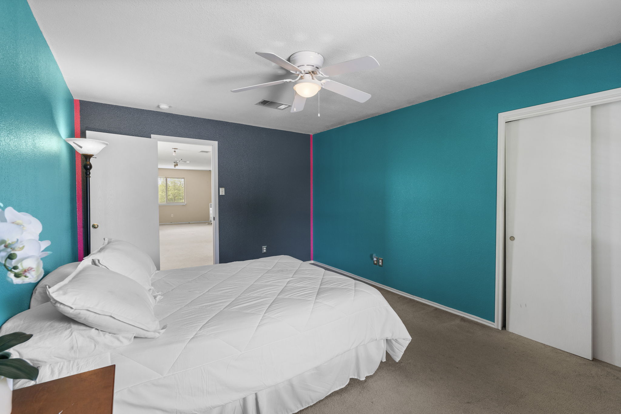 141 Sydney's Way Buda, TX 78610 - Photo 22 of 37 a bedroom with a large bed and chandelier