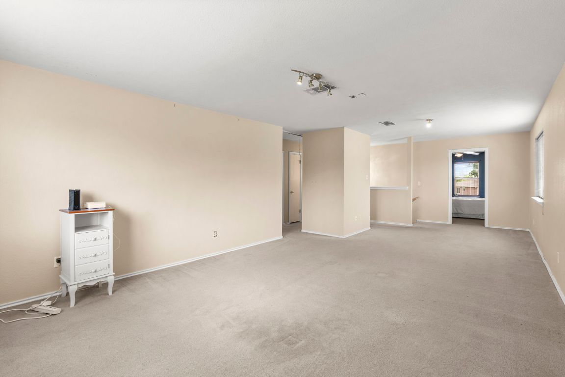 141 Sydney's Way Buda, TX 78610 - Photo 23 of 37 an empty room with a empty space and windows