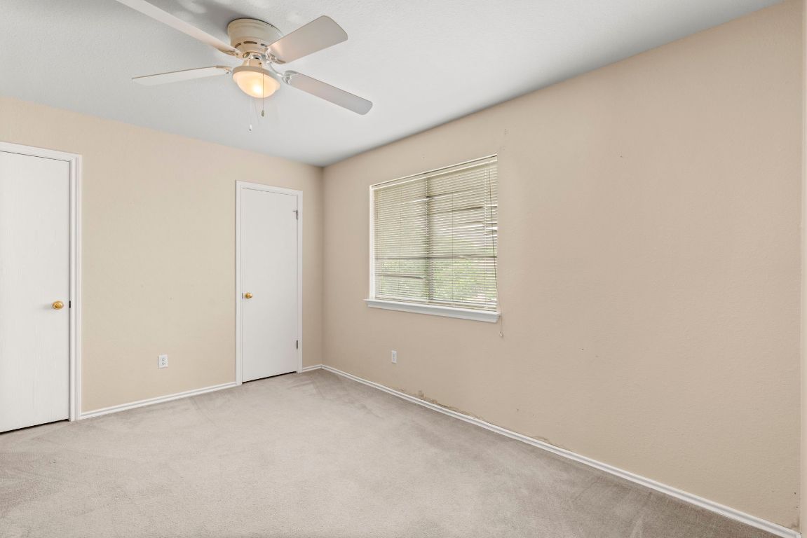 141 Sydney's Way Buda, TX 78610 - Photo 25 of 37 an empty room with a window and a fan