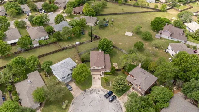 an aerial view of a house with a yard