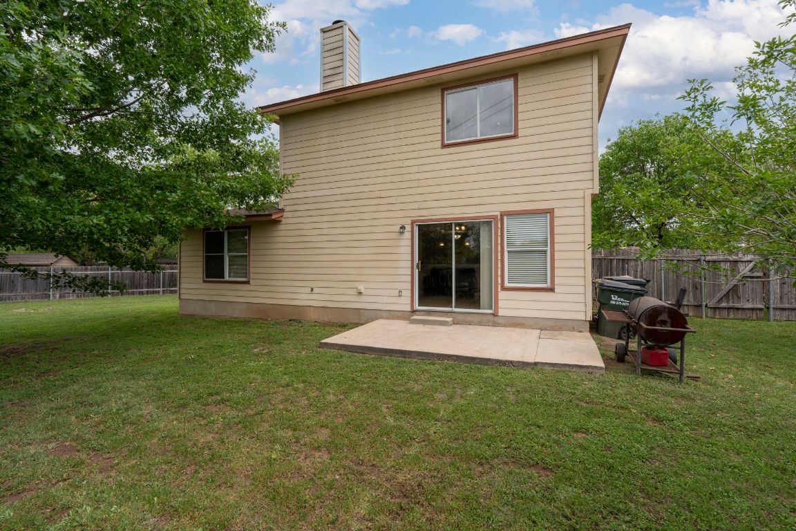 141 Sydney's Way Buda, TX 78610 - Photo 4 of 37 a view of backyard of house with outdoor seating and green space