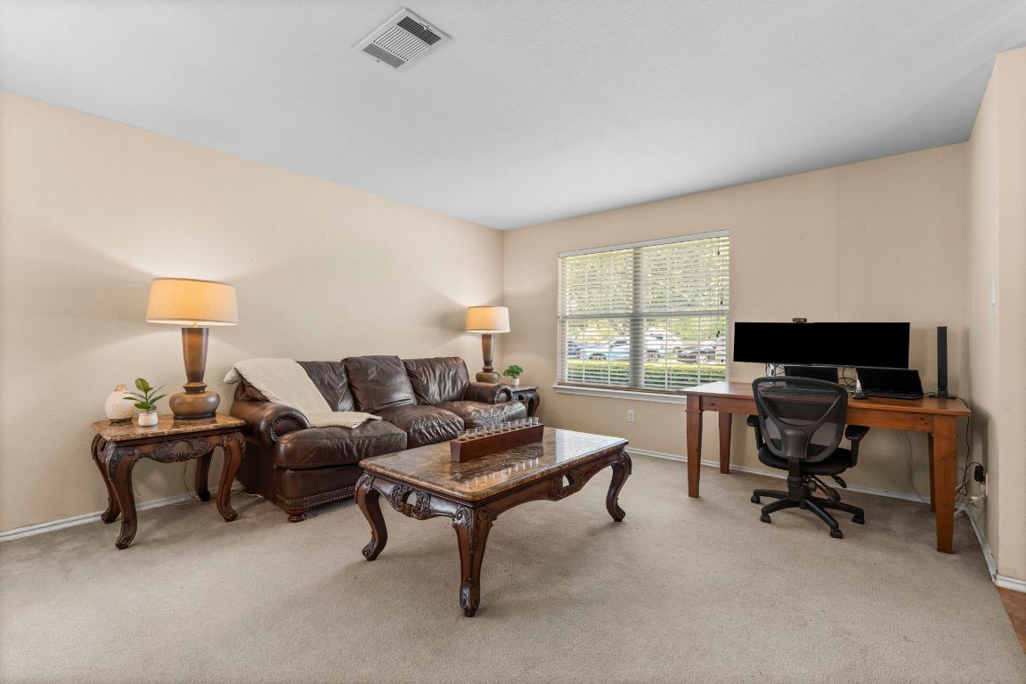 141 Sydney's Way Buda, TX 78610 - Photo 9 of 37 a living room with furniture a window and a flat screen tv