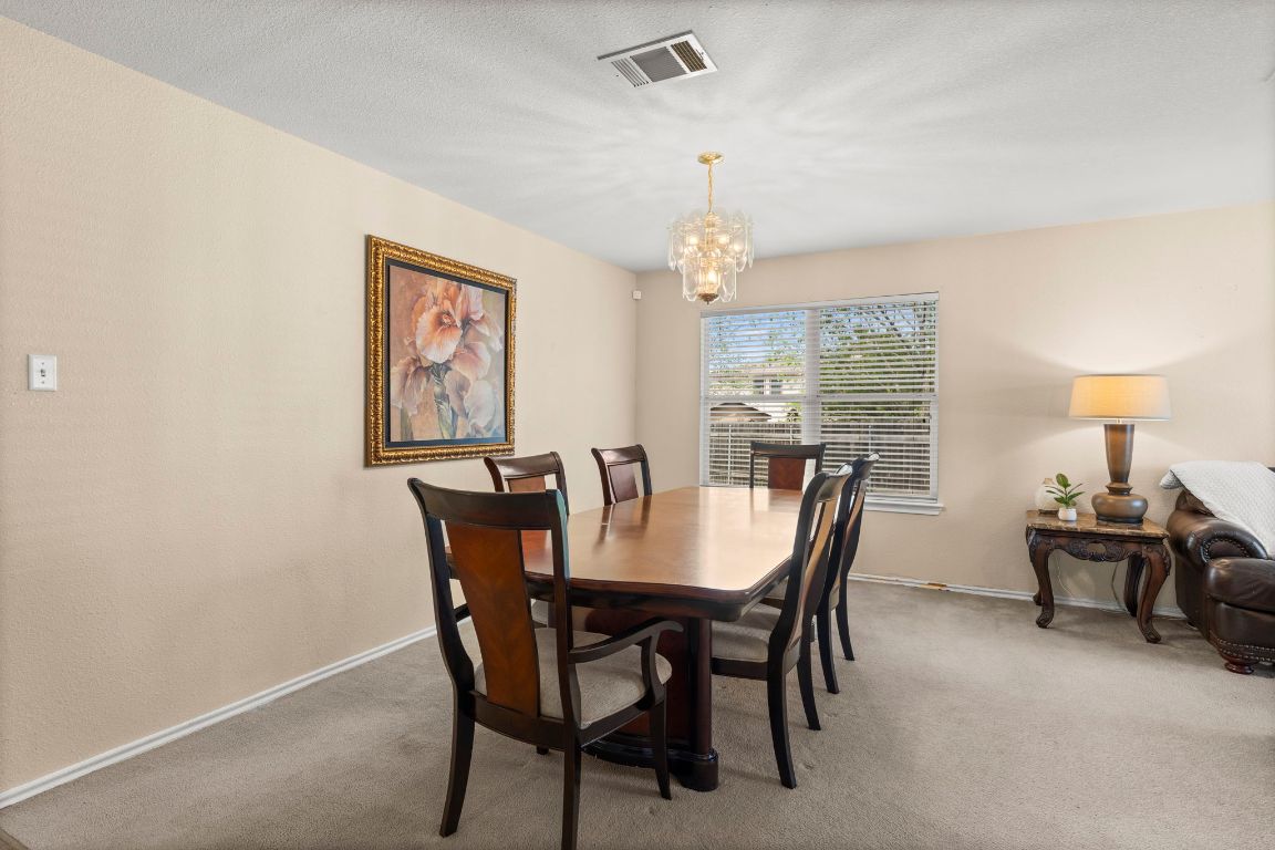141 Sydney's Way Buda, TX 78610 - Photo 10 of 37 a view of a dining room with furniture window and outside view