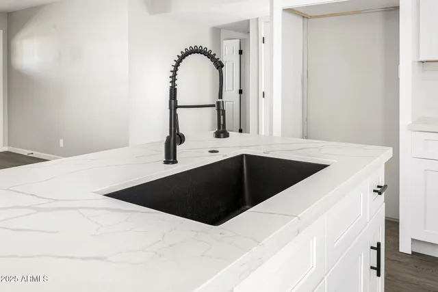 a kitchen with a sink and a mirror