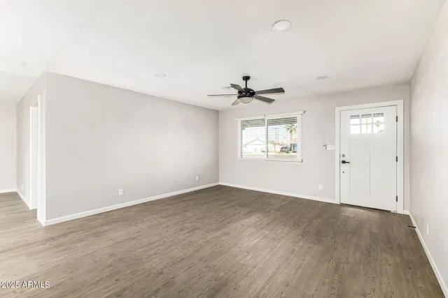 an empty room with windows and closet
