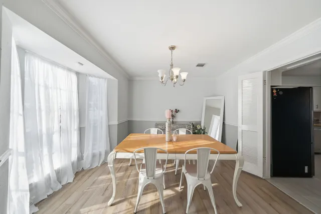 a view of a dining room with furniture and window