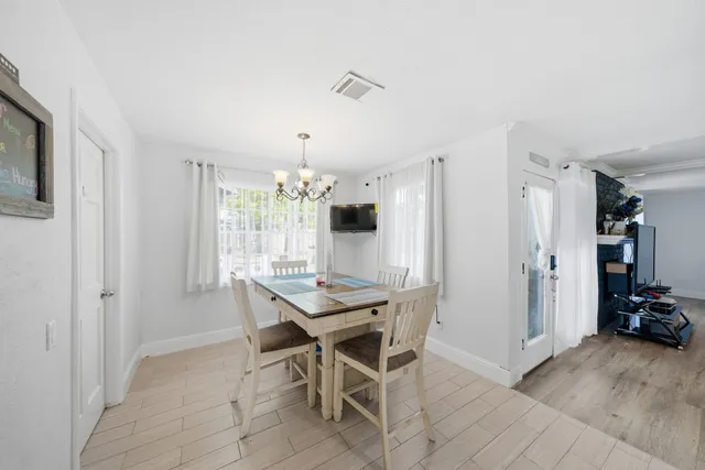 a view of a dining room with furniture and window