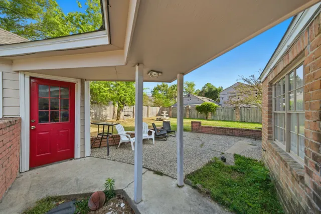 a view of a porch with chairs and backyard
