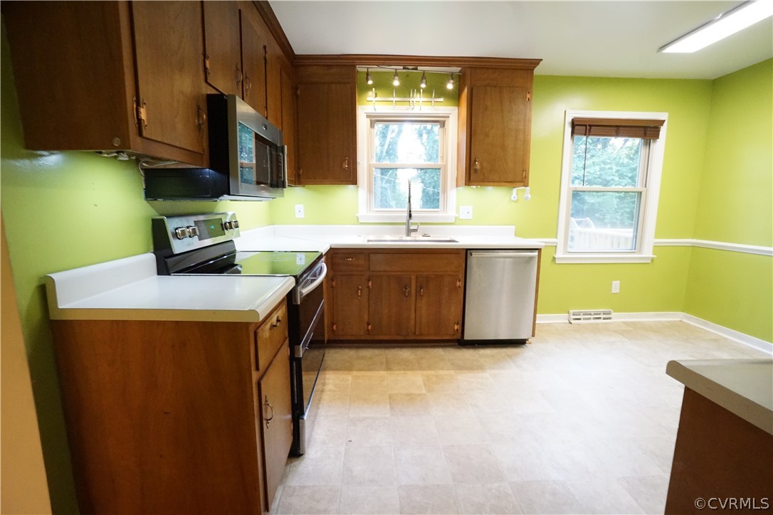 10110 Oldham Road Richmond, VA 23235 - Photo 15 of 26 a kitchen with granite countertop a sink a stove top oven cabinets and a window