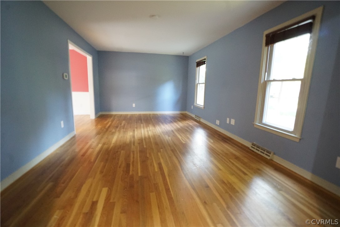 10110 Oldham Road Richmond, VA 23235 - Photo 7 of 26 an empty room with wooden floor and windows