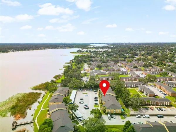 an aerial view of residential building and lake