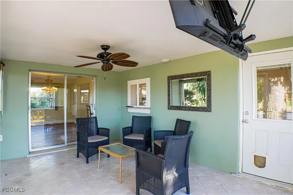 a view of a livingroom with workspace and a window
