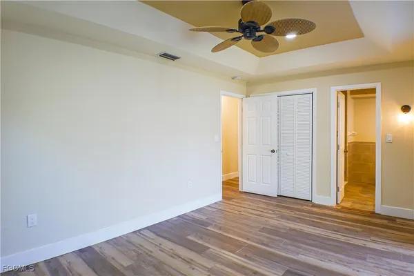 a view of empty room with wooden floor