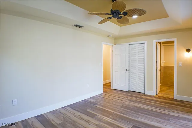 a view of empty room with wooden floor