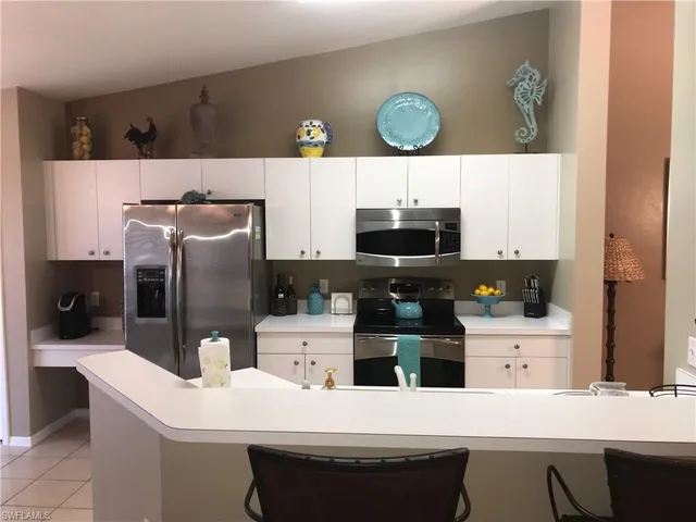 a kitchen with stainless steel appliances a sink and a refrigerator