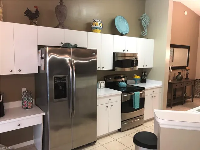 a kitchen with stainless steel appliances a refrigerator and a stove top oven
