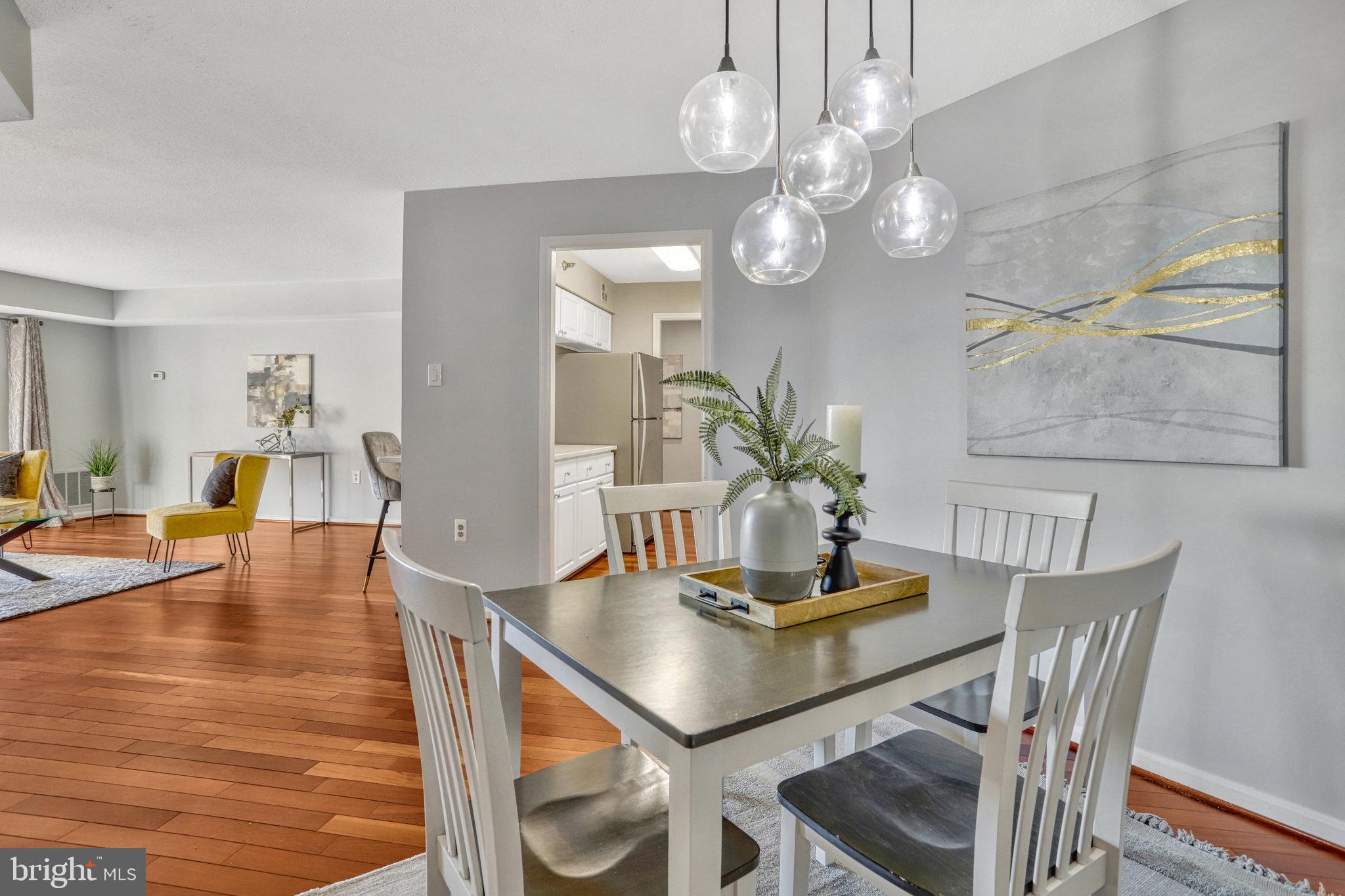 1301 North Courthouse Road, Unit 1610 Arlington, VA 22201 - Photo 12 of 41 a view of a dining room with furniture and wooden floor