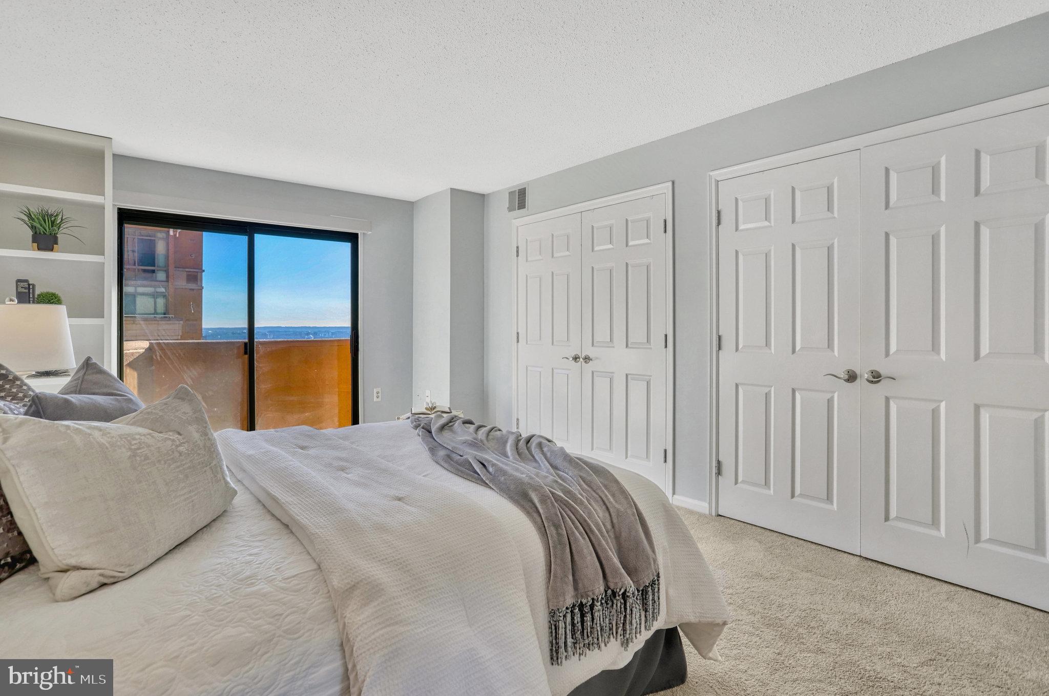 1301 North Courthouse Road, Unit 1610 Arlington, VA 22201 - Photo 17 of 41 a bed sitting in a spacious bedroom next to a window
