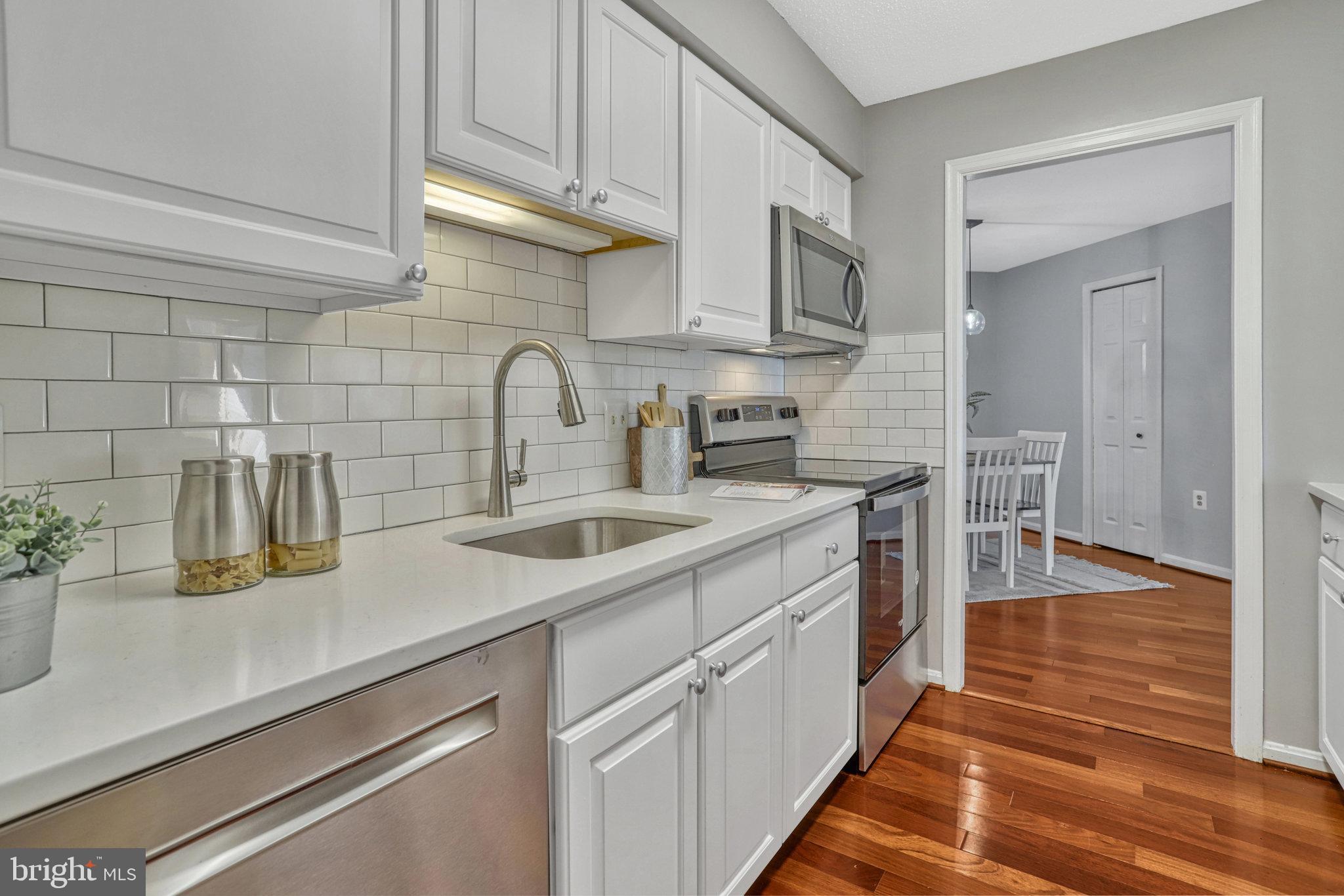 1301 North Courthouse Road, Unit 1610 Arlington, VA 22201 - Photo 8 of 41 a kitchen with stainless steel appliances granite countertop a sink and cabinets
