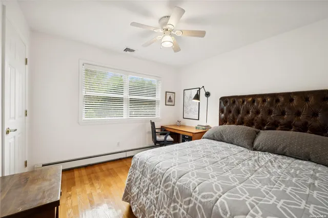 a bedroom with a large bed and a window