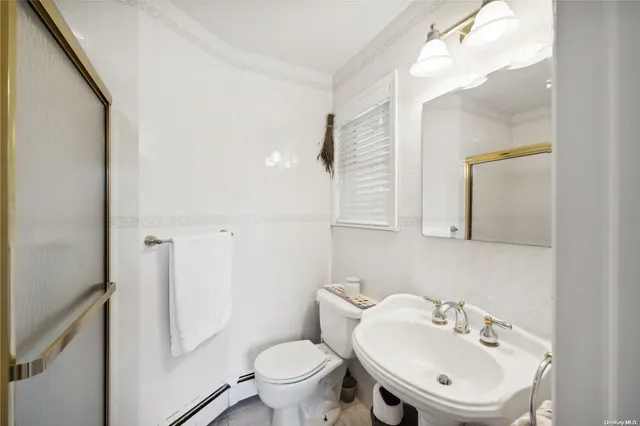 a bathroom with a sink mirror and toilet