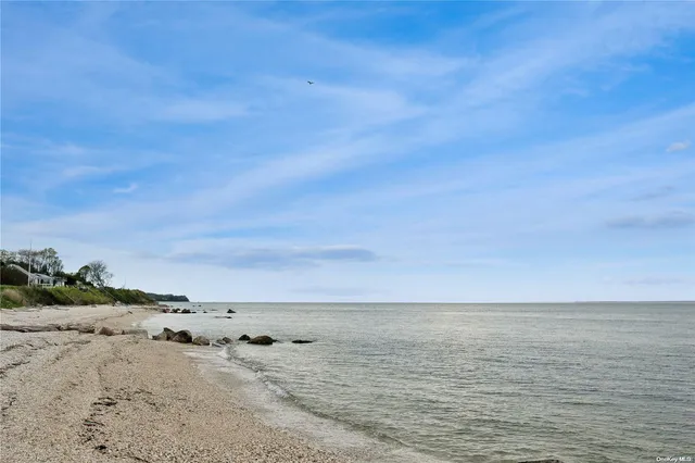 a view of a big house with a big yard and large trees