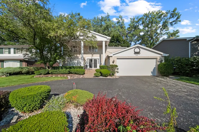 a front view of a house with a yard and outdoor seating