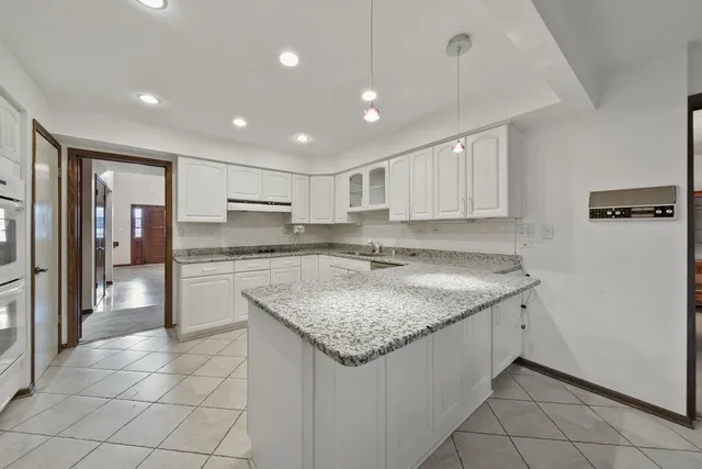 a kitchen with a sink a counter top space cabinets and stainless steel appliances