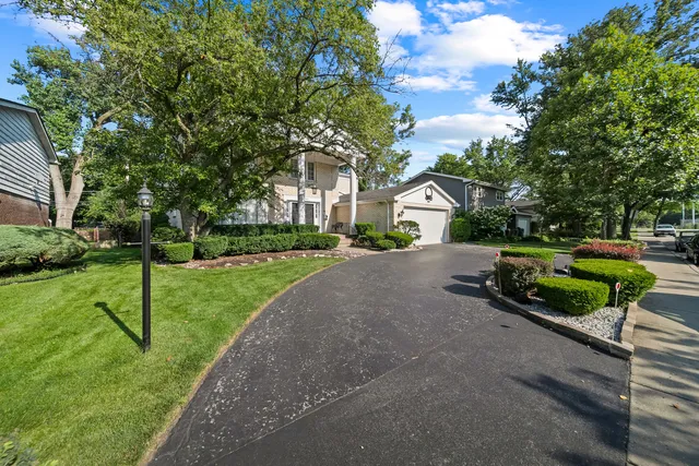 a house with green field in front of it