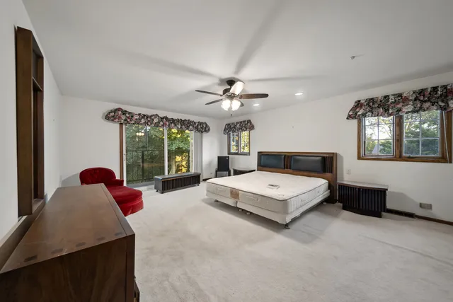a living room with furniture large window and a chandelier