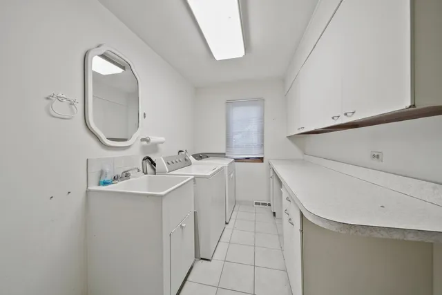 a bathroom with a double vanity sink and mirror