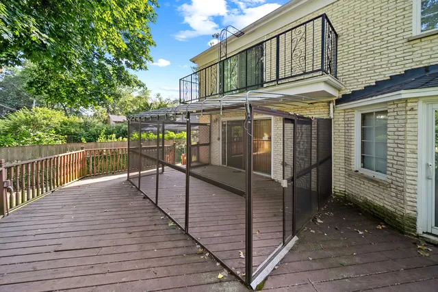 a view of a house with backyard and deck