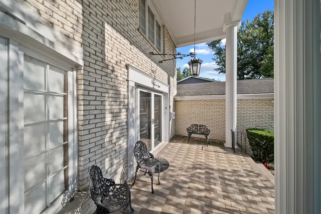 a view of a patio with table and chairs potted plants