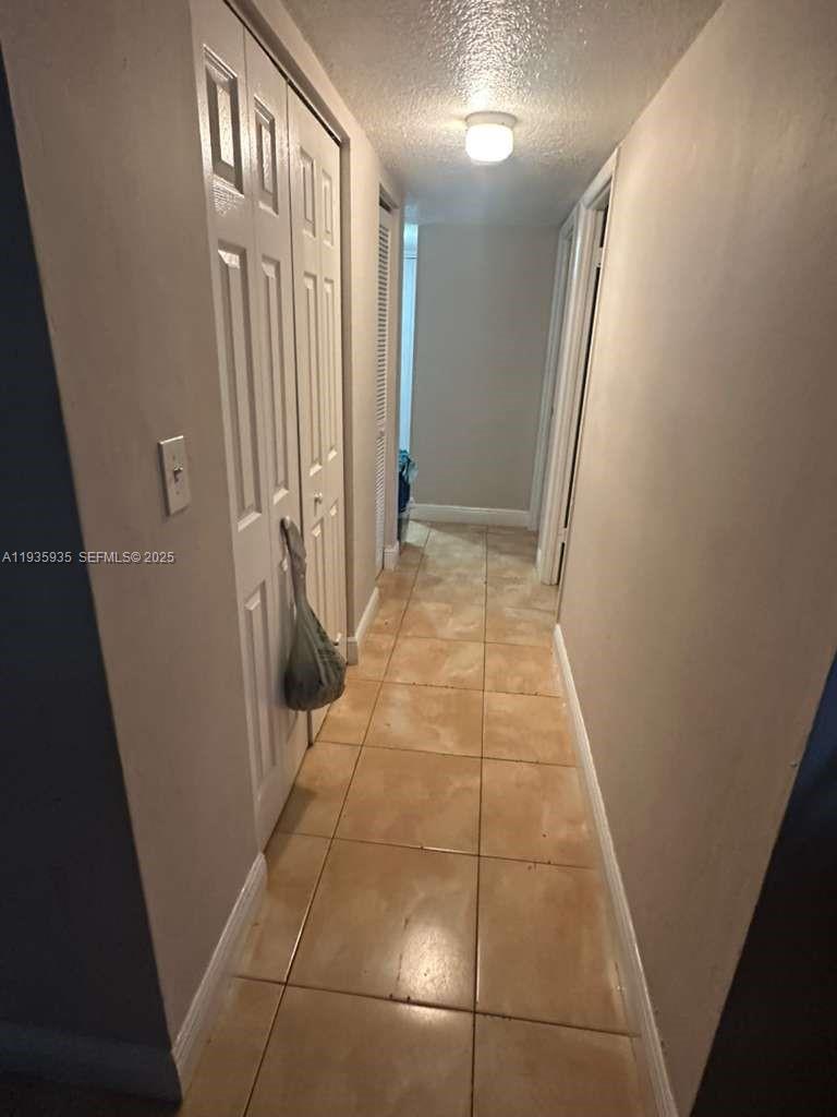 1875 West 56th Street, Unit 301 Hialeah, FL 33012 - Photo 15 of 17 a view of a hallway