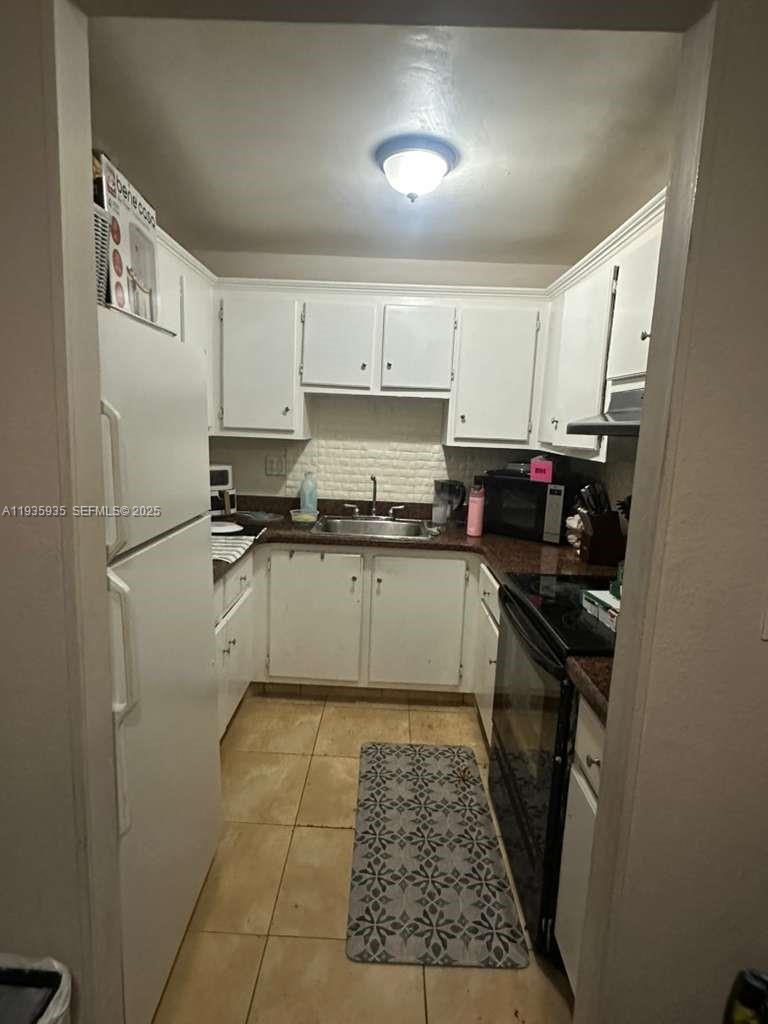 1875 West 56th Street, Unit 301 Hialeah, FL 33012 - Photo 16 of 17 a kitchen with stainless steel appliances granite countertop a stove a sink and a refrigerator