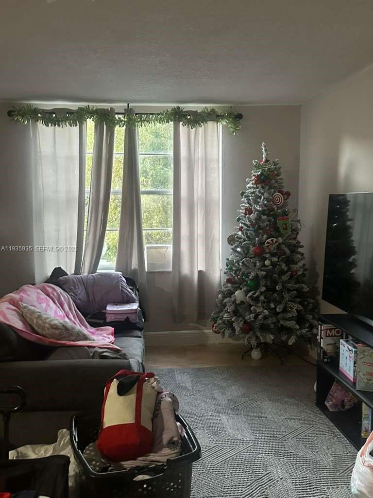 1875 West 56th Street, Unit 301 Hialeah, FL 33012 - Photo 17 of 17 a living room with furniture and a flat screen tv