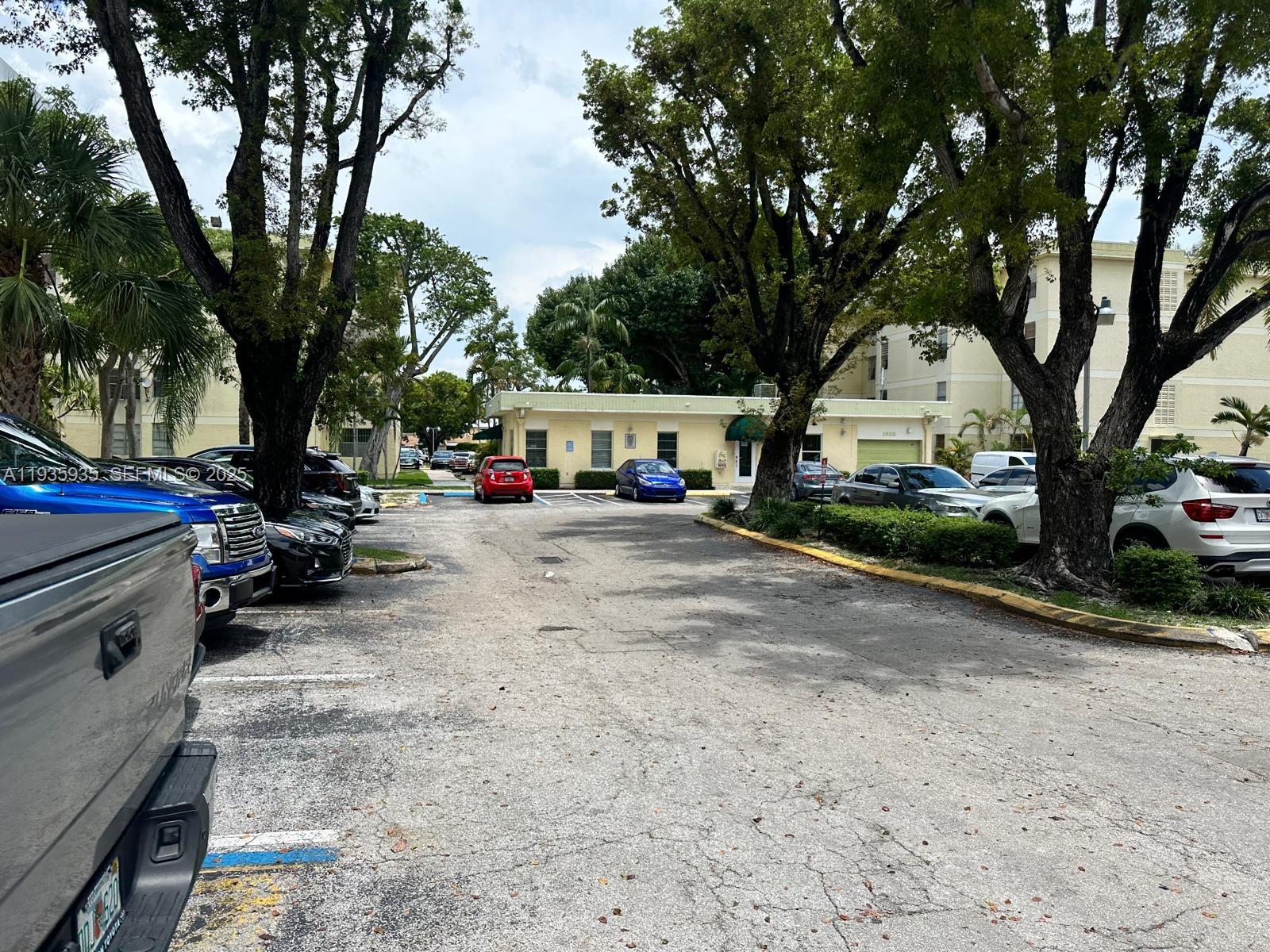 1875 West 56th Street, Unit 301 Hialeah, FL 33012 - Photo 6 of 17 a view of street with trees and houses