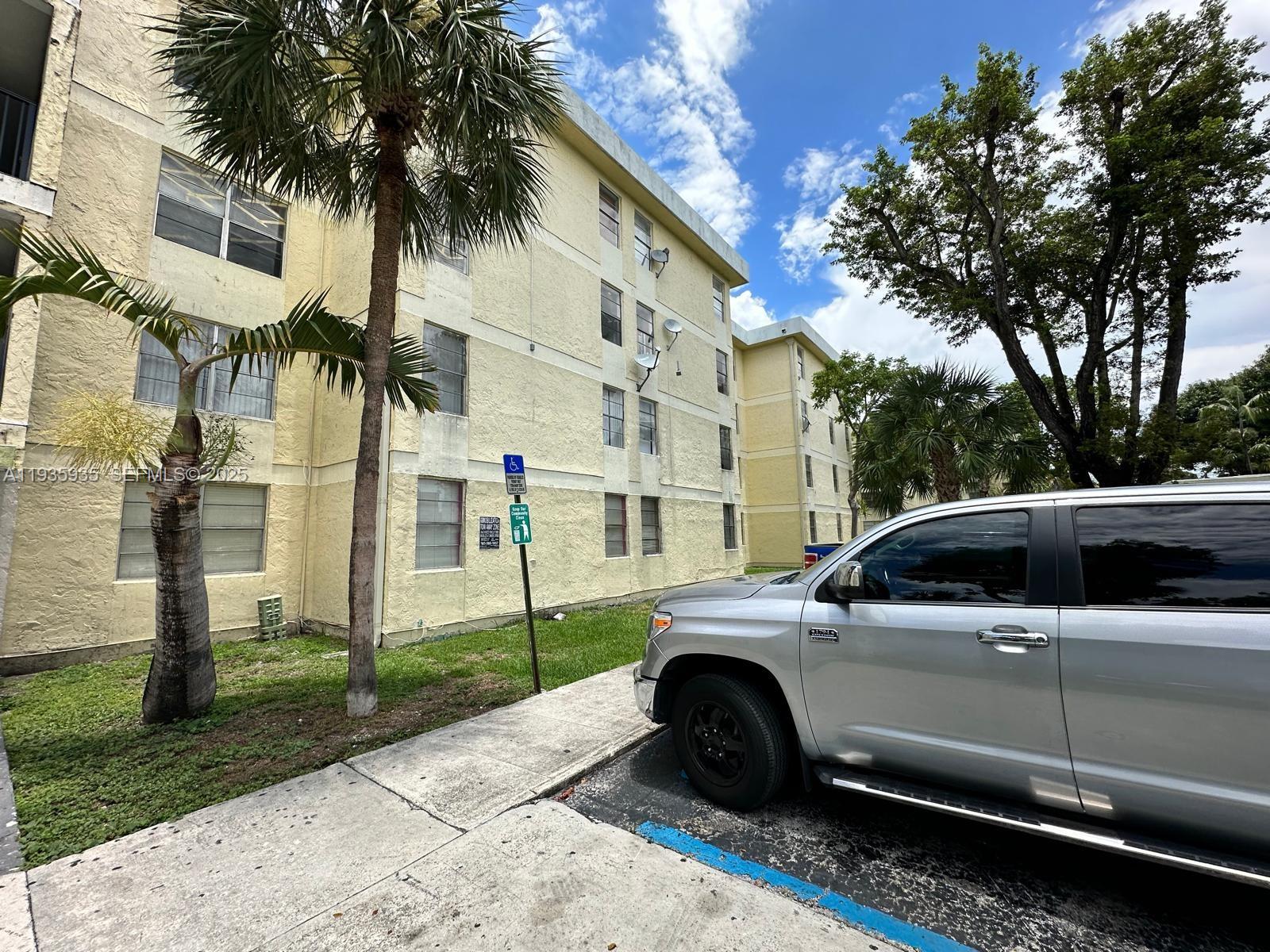 1875 West 56th Street, Unit 301 Hialeah, FL 33012 - Photo 7 of 17 a view of a car parked in front of house