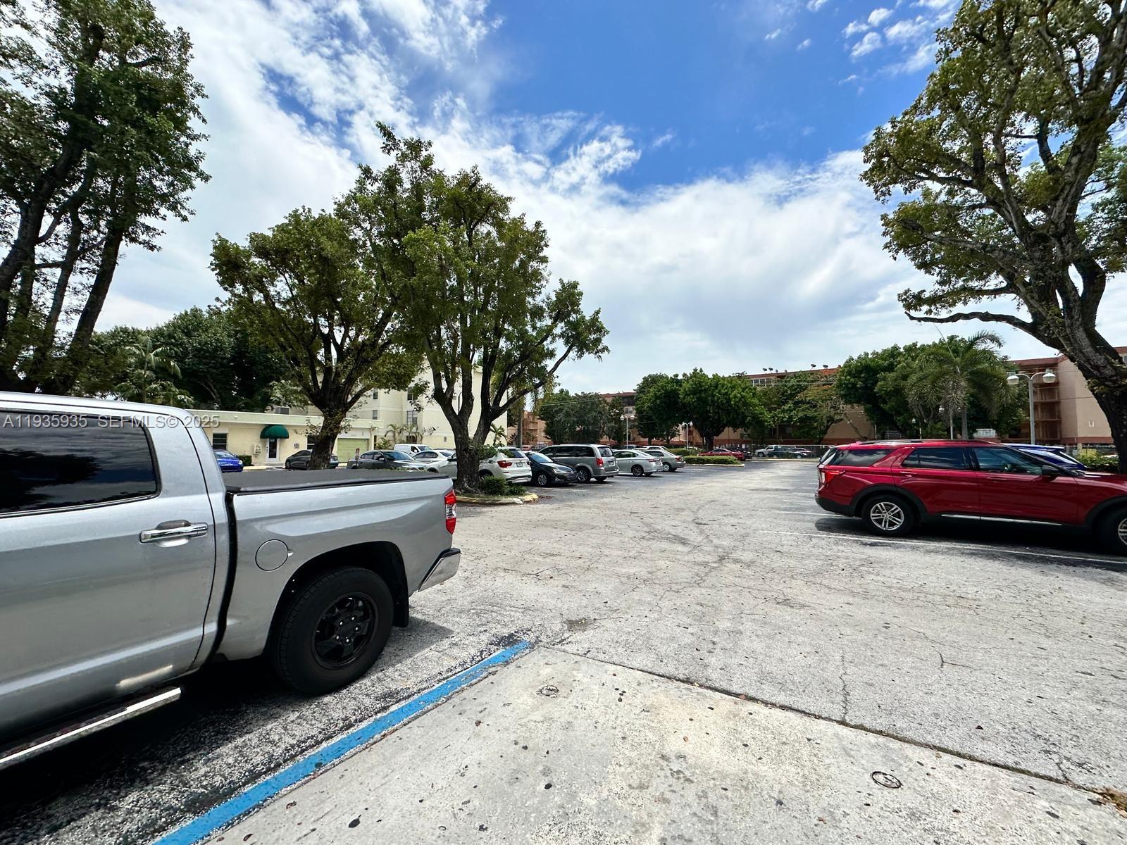 1875 West 56th Street, Unit 301 Hialeah, FL 33012 - Photo 8 of 17 a view of a car parked in a parking lot
