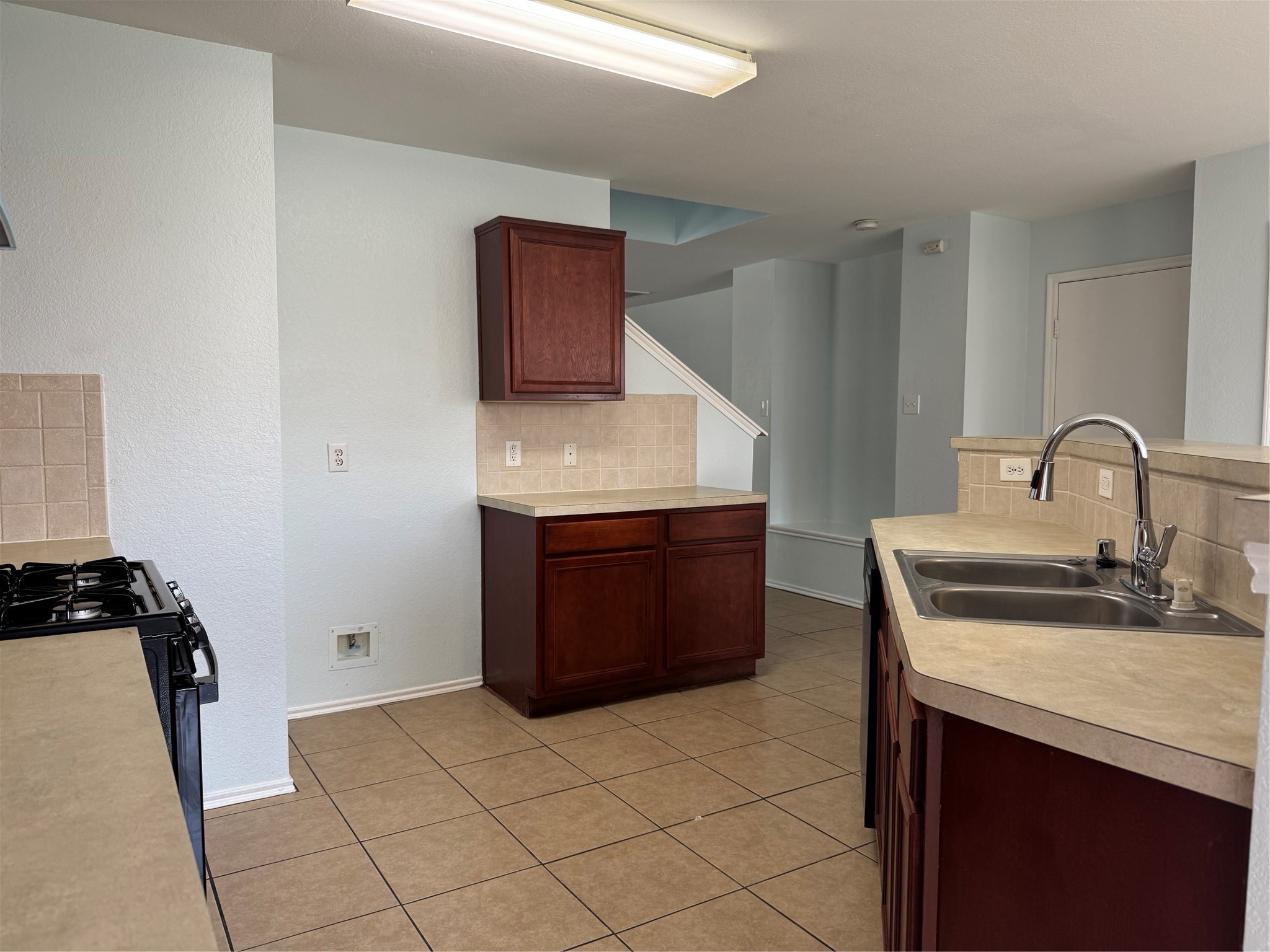 8111 Liberty Point Lane Humble, TX 77338 - Photo 3 of 14 a kitchen with a sink and a stove top oven