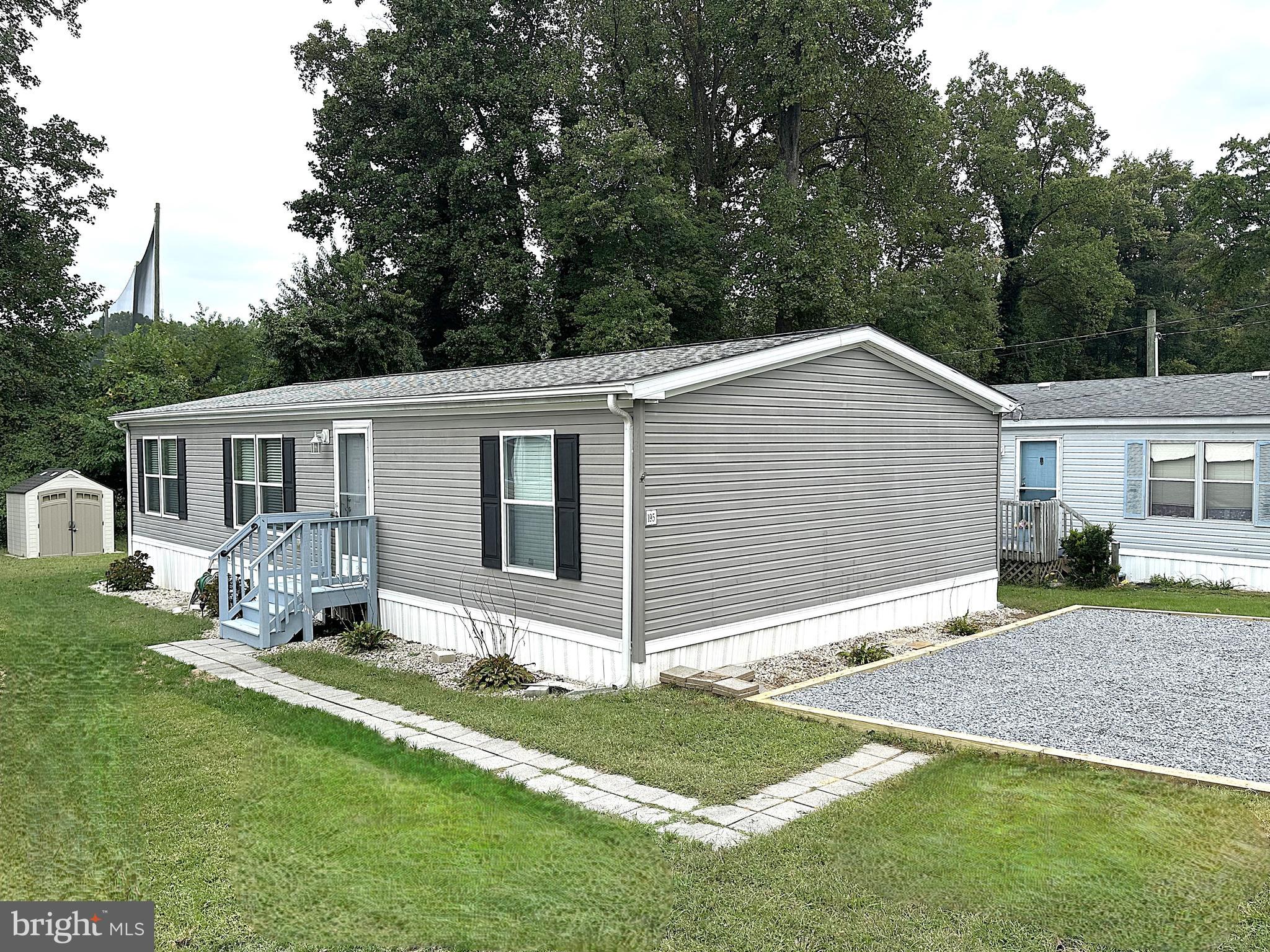 1277 Ritchie Highway, Unit 195 Arnold, MD 21012 - Photo 1 of 30 a view of a house with a yard and chairs