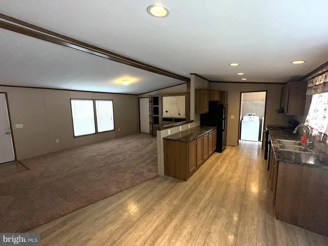 a kitchen with a refrigerator and a stove top oven