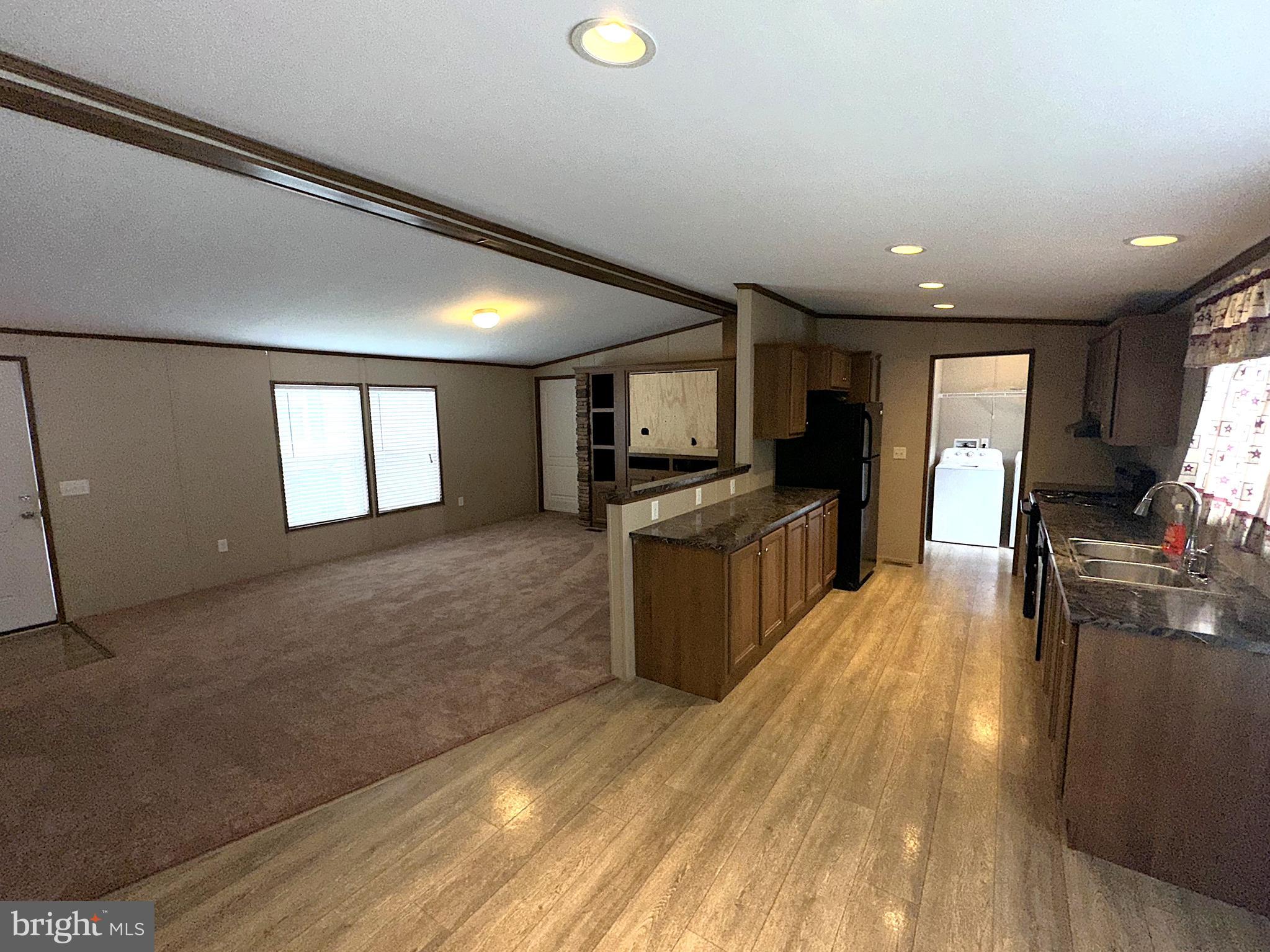 1277 Ritchie Highway, Unit 195 Arnold, MD 21012 - Photo 2 of 30 a kitchen with a refrigerator and a stove top oven